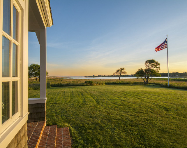 Cottage Backyard. Beach cottage with grassy backyard, ocean view and an American Flag. #Cottage #Backyard #AmericanFlag Via Sotheby's Homes.