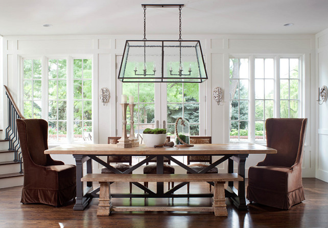Dining Room. Dining Room with lantern pendant, guy chaddock, guy chaddock light, trestle table, sconces, ply lighting, white paneling, large windows, staircase. #DiningRoom