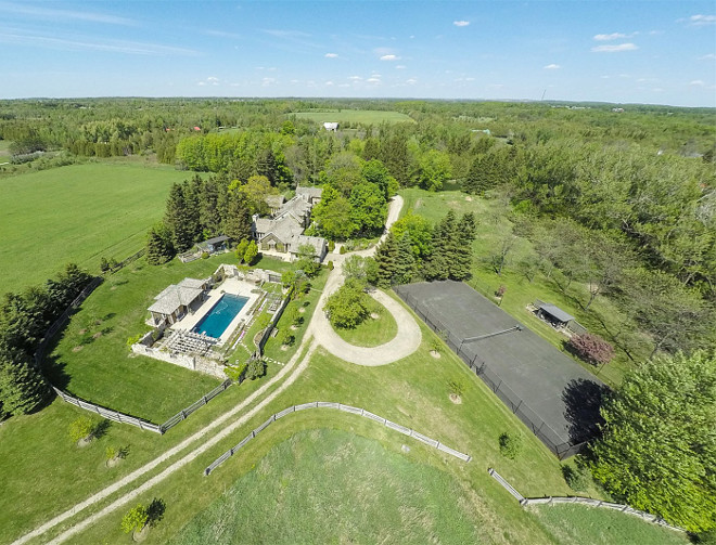 Farmhouse Arial View. French Country Farmhouse Arial View. Home Arial View. A tennis court, in-ground pool with stately pool house, and a private pond are the finishing touches on this beautiful estate. #Farmhouse #FrenchCountry #Home #ArialView