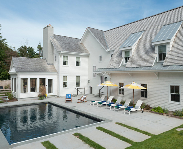 Farmhouse home backyard with pool. Farmhouse with modern concrete decking and pool. #Farmhouse #pool #Pooldecking #Concrete #backyard Blue Water Home Builders.