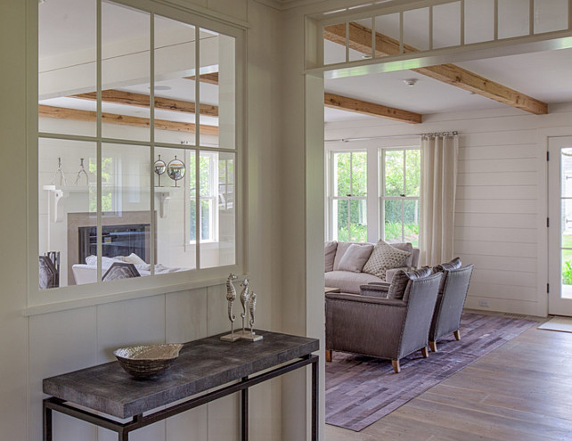 Foyer. Foyer with plank walls, wide plank hardwood flooring, transoms and interior window to expand natural light. #Fioyer #plankWalls #PlankFloors #InteriorWindows Jonathan Raith Inc.