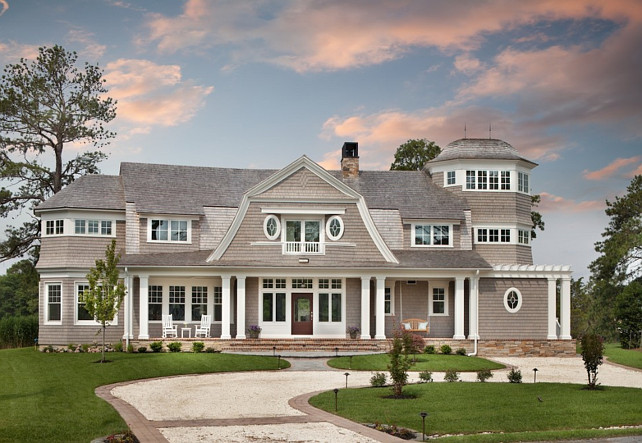 Gambrel Shingle Home Exterior. Gambrel shingle home with oval windows and front porch entry. Anthony Wilder DesignBuild, Inc.