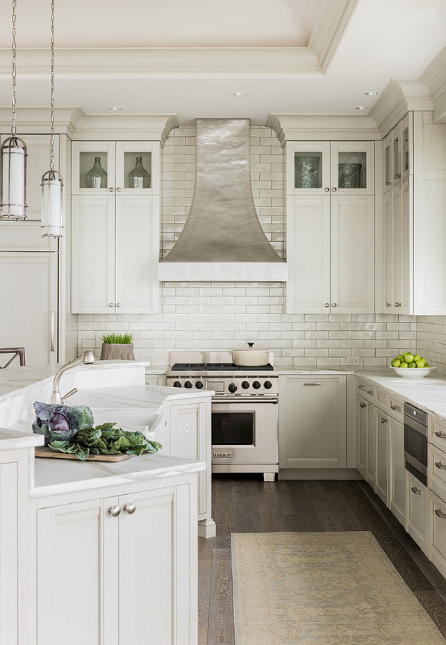 Ivory Kitchen. Ivory Kitchen Cabinet Paint Color. Ivory Kitchen Cabinets. Kitchen with ivory cabinets paired with white marble countertops and a glazed ivory subway tiled backsplash. #IvoryKitchen #IvoryKitchenPaintColor