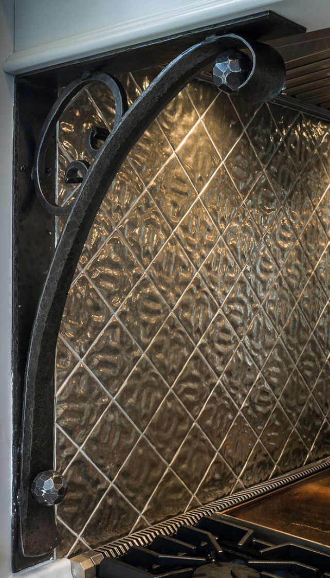 Kitchen Corbels. Custom designed and hand forged Iron Corbels support Hood, metal tiles on backsplash by Rocky Mountain Hardware. #Kitchen #KitchenHood #corbel #MetalBacksplash