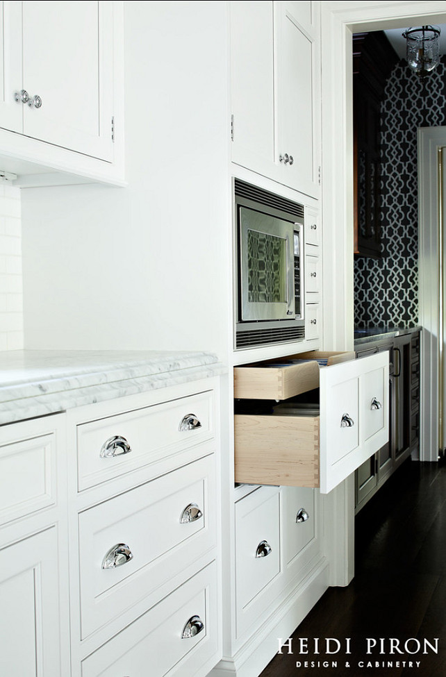 Kitchen Cabinet. Two pots and pans drawers built extra wide and very deep under the microwave allow the homeowners to maximize storage in the open kitchen. The drawers also have a special shallow roll-out that holds lids. #Cabinet #Kitchen #KitchenCabinet 