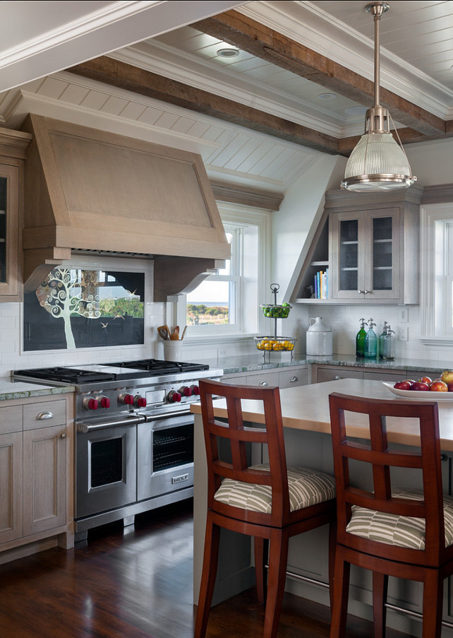Kitchen Ideas. Grey washed kitchen cabinets with beautiful ceiling.What really grabs your attention in this kitchen is the reclaimed wood beams and planked ceiling. The countertop in this kitchen is honed granite and the island is stained wood. Island pendant are the "Haverhill Pendant by Hudson Valley Lighting". #KitchenIdeas. #Kitchen