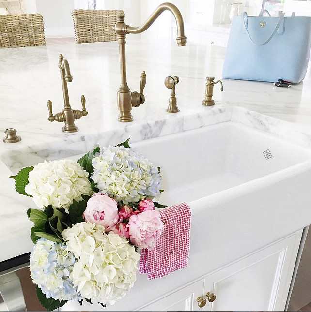 Top Kitchen Faucet Pin. Kitchen Island with Farmhouse sink and brass kitchen faucet. Via Pink Peonies.