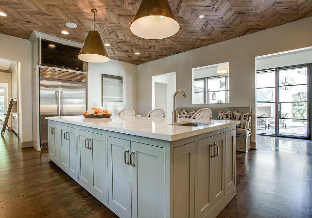 Kitchen Lighting. Amazing kitchen features a wood herringbone ceiling accented with Goodman Hanging Lamps illuminating a gray kitchen island. #Kitchen #KitchenLighting Avrea Wagner Interiors.