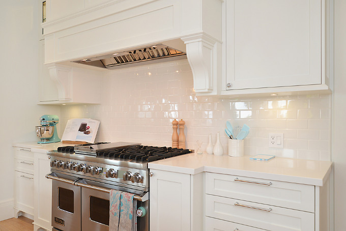 Kitchen Range Cabinet and Hood Ideas. Classic kitchen combination of white cabinet with white quartz countertop and white subway tile backsplash. The kitchen cabinet paint color is Fossil Dust" CLW 1043W by General Paint. Sunshine Coast Home Design.