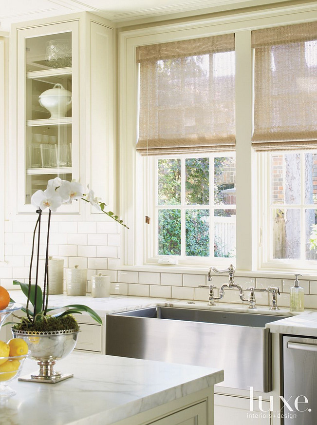 Kitchen sink and backsplash. A farmhouse sink and faucet from Fixtures & Fittings stand out against backsplash tiles from Ann Sacks. #Kitchen #Farmhousesink #Sink #backsplash Courtney Hill Fertitta.