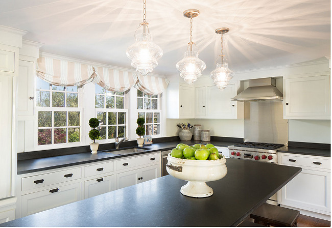 Kitchen window with shades. Casabella Home Furnishings & Interiors.