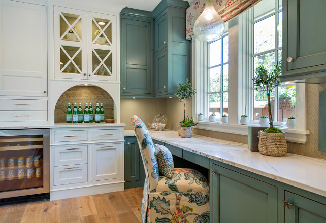 Kitchen with desk and bar. Kitchen with desk with cabinets painted in blue and kitchen bar cabinets painted in white. Walls are covered in a herringbone patterned wallpaper. Great Neighborhood Homes.