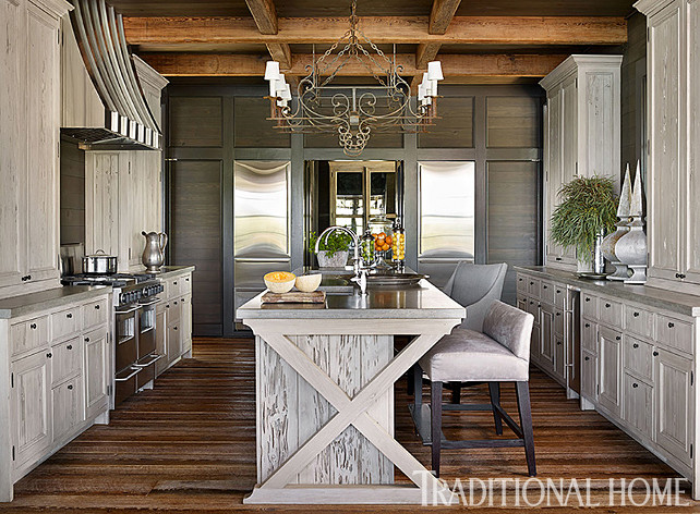 Kitchen. Rustic Kitchen Design. The integration of rustic design, materials, and craftsmanship is fully expressed in the kitchen, with its custom-made cabinets and reclaimed wood floors. Upholstered stools and a low-back dining bench are from the McAlpine Home Collection for Lee Industries. Cabinetry hardware is by Baldwin Hardware (a favorite of mine as well). Flooring is reclaimed wood with a hand-brushed custom finish. Countertop is concrete. #Kitchen #RusticKitchen #KitchenDesignIdeas #KichenCabinet #BeautifulKitchens