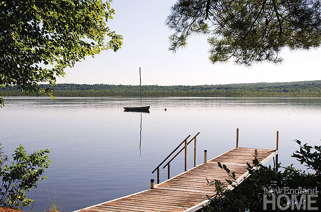 Lake. Lake house with dock and boat. Boating, swimming and docks to leap off make this the perfect spot for family fun. #Lake #LakeHouse #Dock #Boat New England Home Magazine.
