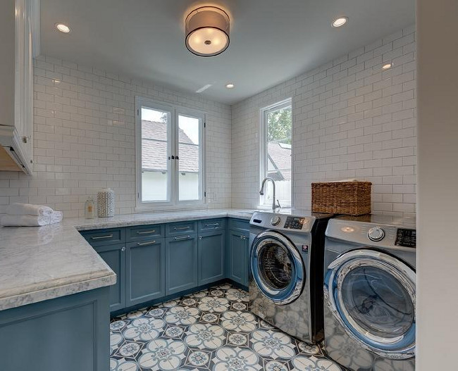 Laundry Room. Blue and white laundry room. Two toned laundry room cabinets. Two toned laundry room cabinets painted in blue and white, white subway tiles and cement tile flooring. Sotheby's Homes.