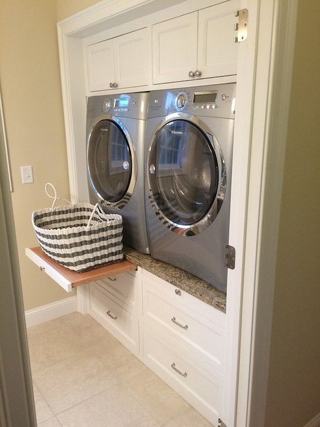 Laundry Room. Laundry Room Ideas. Laundry room machine ideas that are easy on your back. Enclosed Washer and Dryer | Laundry room features built-in cabinets encasing a silver front-load washer and dryer accented with pull out trays sandwiched between cabinets above and stacked drawers below. Via Decorpad. 