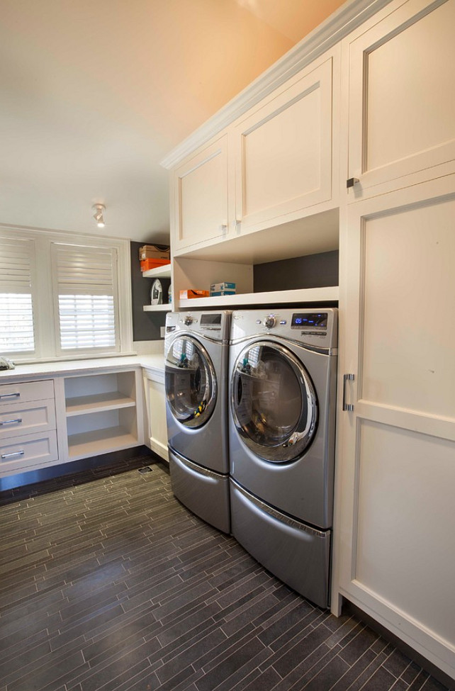 Laundry Room. Laundry Room with durable flooring and deep custom cabinets. #LaundryRoom John Johnstone.