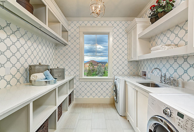 Laundry room. Galley style laundry room with blue quatrefoil wallpaper. Do you like having the laundry machines separate? It's not very practical in my opinion. Clark and Co Homes.