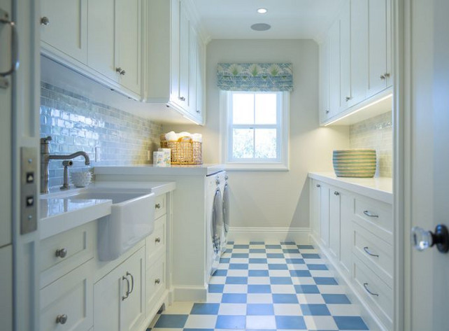 Laundry room. Laundry room with checkered floors. Laundry room. Laundry room with checkered floors. #checkeredfloors #laundryroom Kelly Nutt Design. Great white and blue laundry rooms featuring white shaker cabinets paired with glazed blue tiled backsplash atop white and blue checkered tiled floor. A farmhouse laundry room sink paired with stain nickel faucet stands next to a white front-load washer and dryer across from a laundry folding station. #checkeredfloors #laundryroom Kelly Nutt Design.