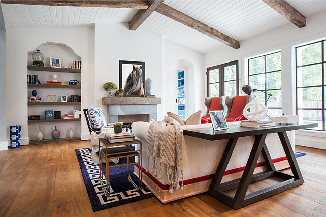 Living Room with cathedral ceiling, beadboard, reclaimed beams and Horse Art above fireplace mantel. Laura U, Inc.