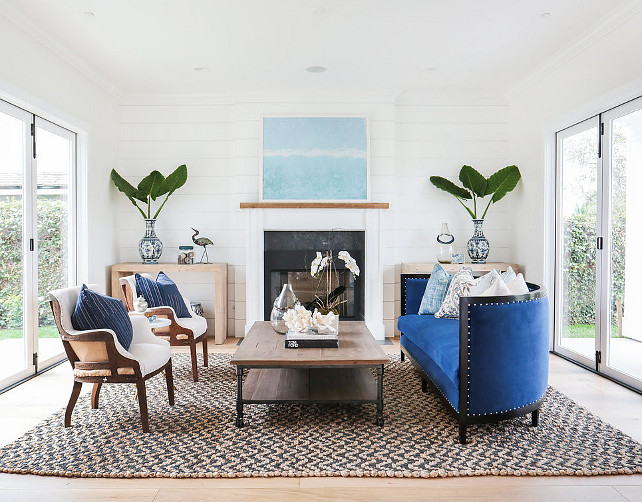 Living room. Transitional living room with blue and white decor, natural fibre rug, reclaimed wood coffee table and tongue and groove accent wall. #livingRoom Blackband Design.