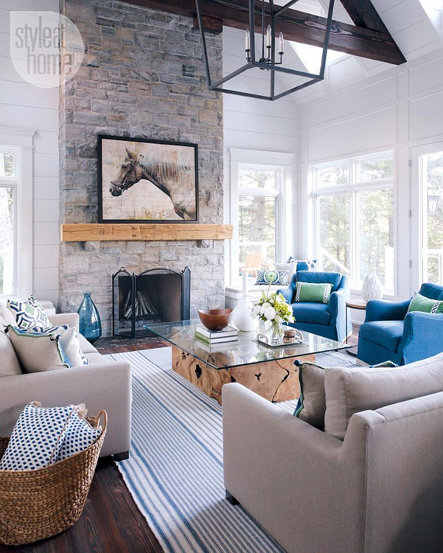 Muskoka Cottage Living Room. Living Room with tall stone fireplace. #Muskoka #Cottage #LivingRoom #Fireplace #StoneFireplace Bachly Construction via Style at Home.