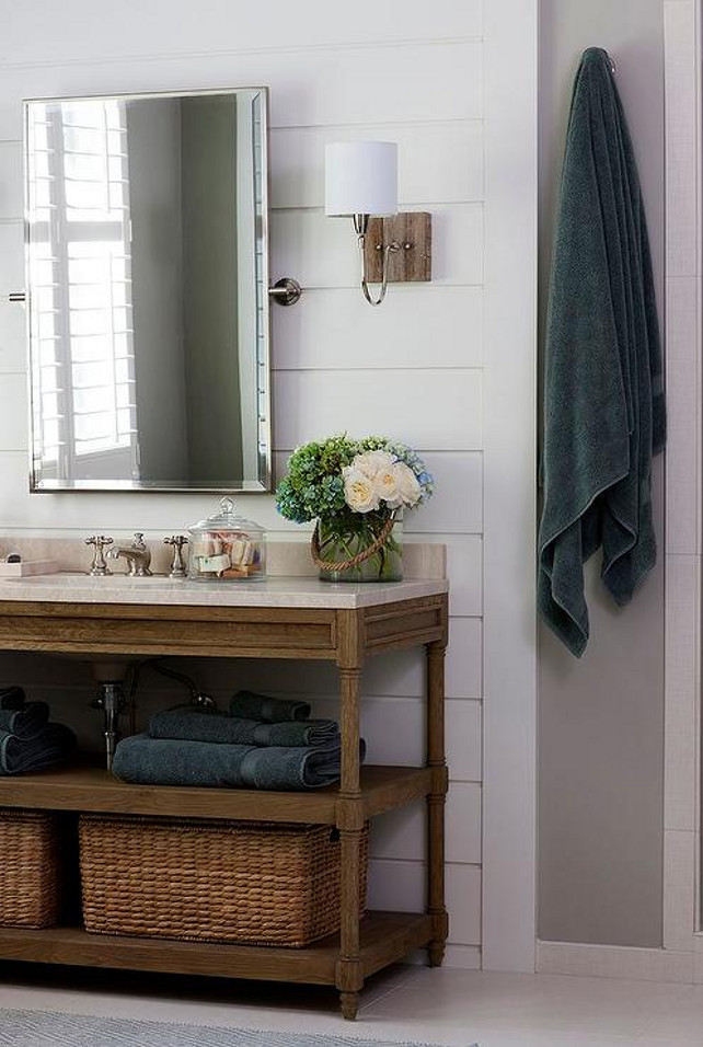 Open Bathroom Vanity with baskets. Bathroom with horizontal shiplap walls lined with a Restoration Hardware Weathered Oak Double Washstand with Italian Crema Marble Countertop placed under a rectangular pivot mirror illuminated by polished nickel and rustic wood sconces. Kristin Peake Interiors. #Bathroom #Vanity #Baskets