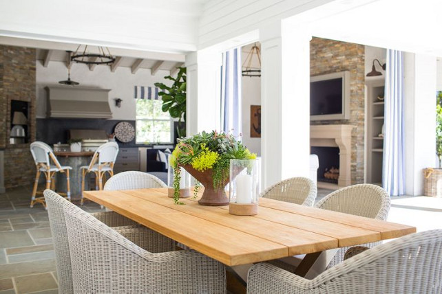 Outdoor dining room. Outdoor dining room with whicker chairs and farmhouse table. Kelly Nutt Design.
