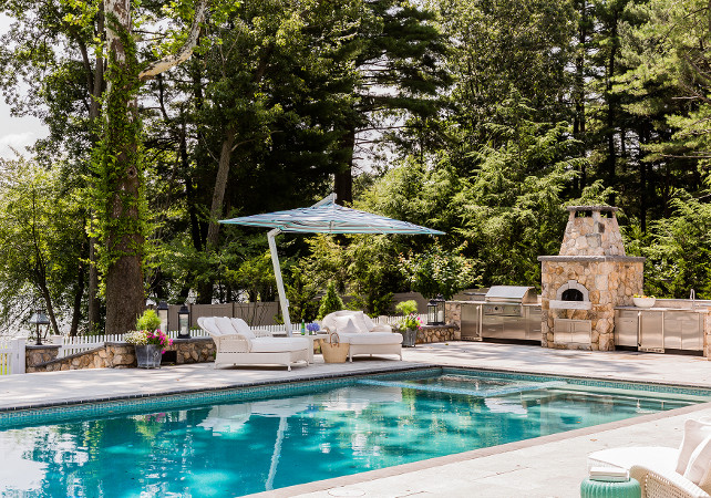 Pool Area with outdoor kitchen. The pool features an amazing outdoor kitchen with its own pizza oven! #Pool #OutdoorKitchen #Kitchen #Backyard Brookes and Hill Custom Builders.
