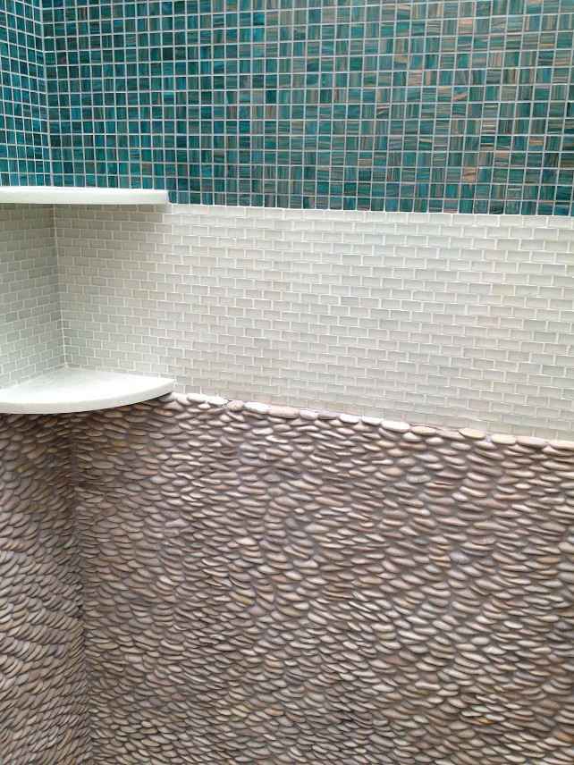 Shower Tiling. Coastal Shower Tiling. This open, coastal shower boasts a beautiful three-tile wall with turquoise, white, and then stone tiling. #Shower #Tiling #ShowerTiling #Coastal #OpenShower #Bathroom