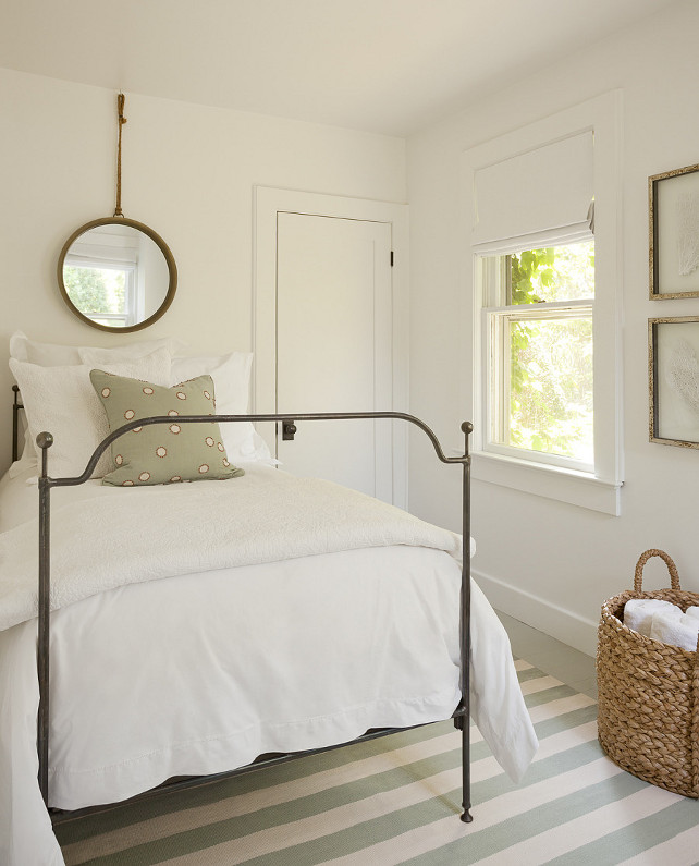 Small Bedroom Design. Small Bedroom Decor. How to design a small bedroom to make it appear bigger. I simply adore this bedroom. Isn't it great? What a calming, serene color palette. The bedroom boasts a vintage mirror hanging over twin metal bed dressed in soft white bedding atop an ivory and mint green striped rug. #SmallBedroom Jenny Wolf Interiors.