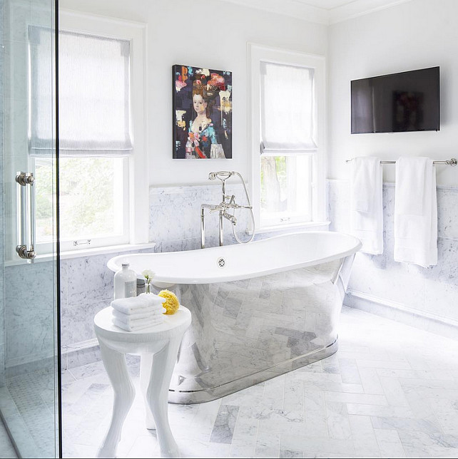 Bathroom wall tiling and Soaking Bath. Bathroom with Soaking Bath and gray and white herringbone flooring. Bathroom wall tiling is 12" x 24" Honed Carrara Marble. #bathroom #SoakingBath Martha O'Hara Interiors.