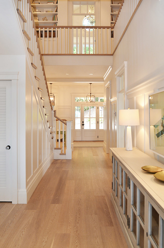 Staircase Landing. Staicase leading to upper level with built-in bookcase. Floors are white oak. Sunshine Coast Home Design.