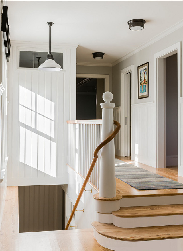 Staircase Ideas. Beautiful classic staircase. Coastal and classic, this staircase has a stunning custom bannister and railing. Coastal-inspired lighting is by Visual Lighting. #Staircase #StaircaseStyles #StaircaseDesign