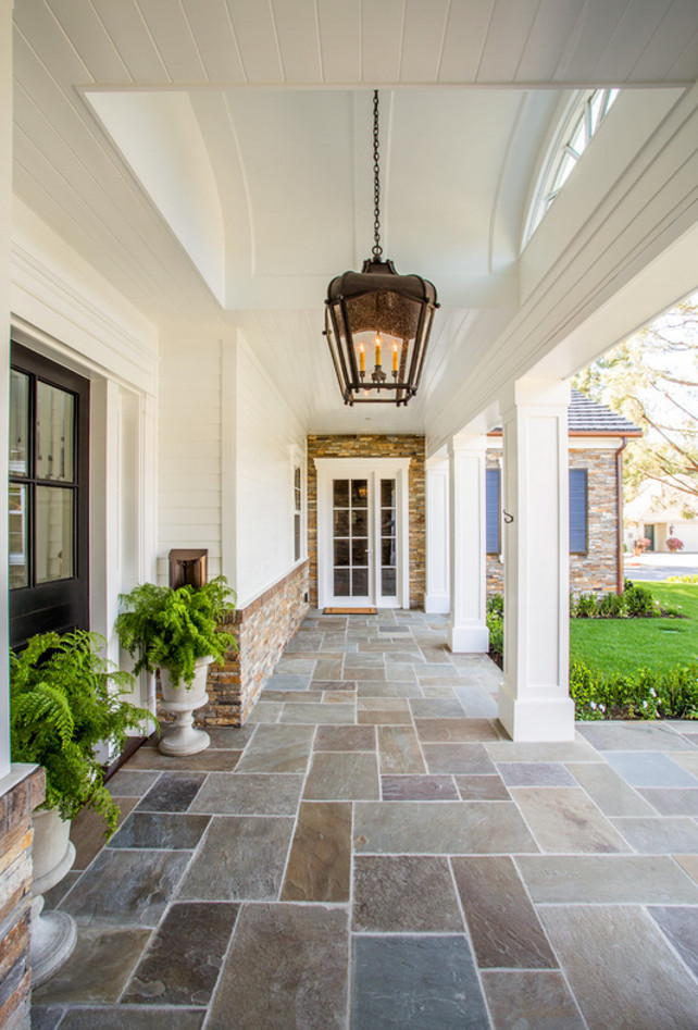 Stone Home Exterior with white siding and stone porch flooring. Stone Home Exterior. #Porch #Stone #Exterior #Homeexterior Legacy Custom Homes, Inc.