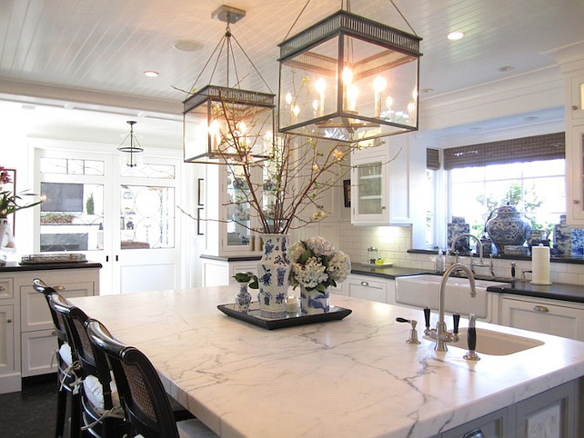 White Marble Kitchen island. Kitchen design with glossy white beadboard ceiling accented with Urban Electric Chisholm Hall Lanterns over calcutta marble kitchen island. #WhiteMarbleKitchenIsland Classic Casual Home.