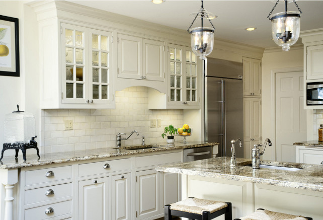 White kitchen cabinets with stainless steel refrigerator. Fivecat Studio.