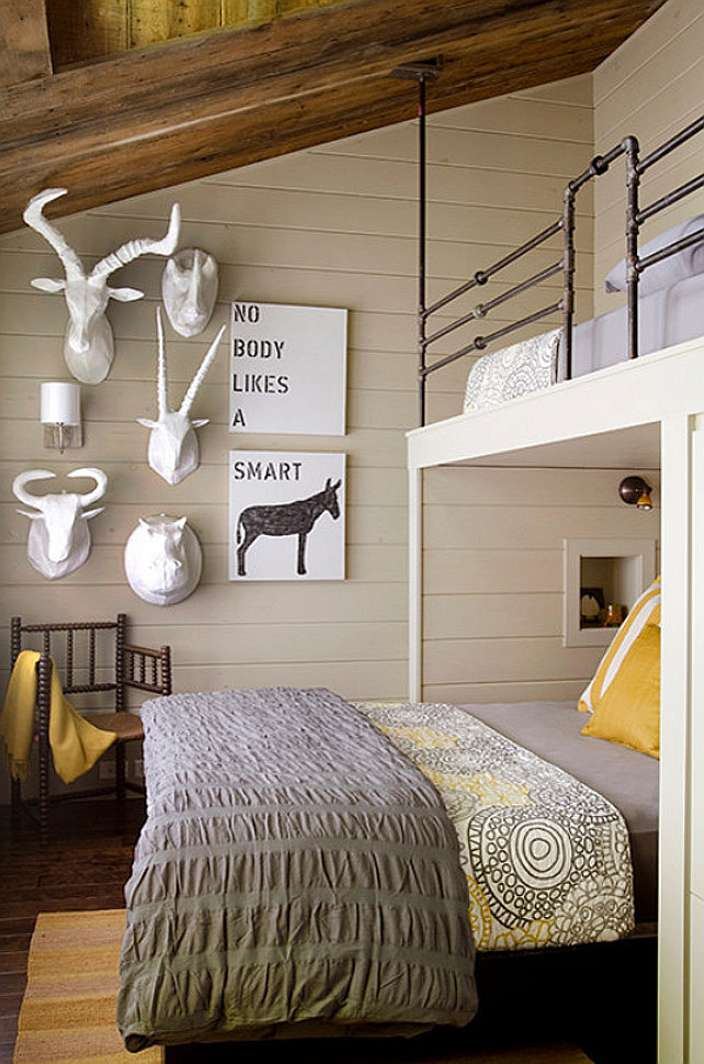 Rustic Bunk Room with funny artwork. Gray and yellow bedroom with barn board ceilings over gray shiplap clad walls accented with a variety of faux taxidermy alongside Nobody Likes A Smart Ass Art. #BunkRoom #Art #Funny