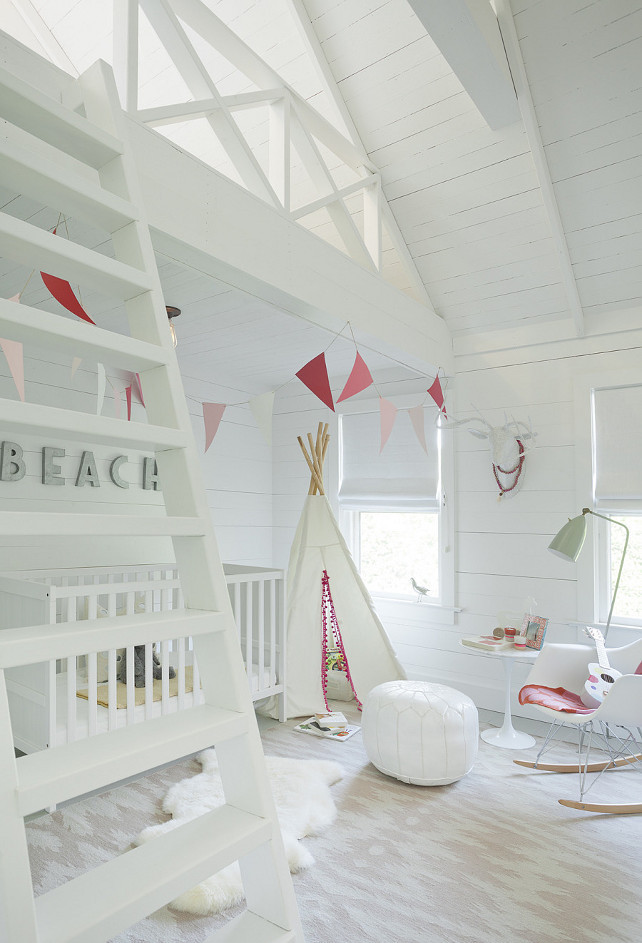 Nursery - Girl Nursery - White Nursery. This nursery boasts an Eames Molded Plastic Rocker, Saarinen Side Table and white Moroccan leather pouf atop a Capel Rugs Junction Pink Flatweave Wool Rug. #Nursery #GirlsNursery 