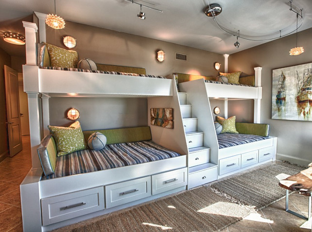 Custom Built Bunk Beds. Four bunk beds with ladder in the middle. Utilized the length and unique shape of the room by building a double twin-over-full bunk wall. #BunkRoom #BunkBed Cara McBroom, Licensed Interior Designer.