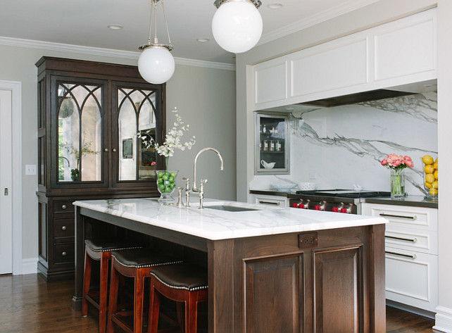 Kitchen. Classic Kitchen with slab backsplash and two-tone cabinets. Kitchn with spice rack in hood nook. #Kitchen #TwoToneCabinet #TwoToneCabinetKitchen #Cabinet #SlabBacksplash #KitchenSpice #HoodNook Jean Stoffer Design. 