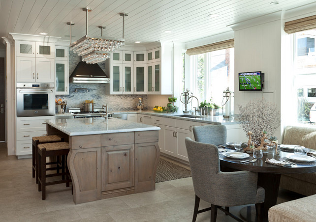 Kitchen. Beach House Kitchen. Beach House Kitchen Ideas. The kitchen in this beach house features quartzite slabs countertop and an alder island. The marble mosaic backsplash evokes the tides, as does the runner in front of the sink. #Kitchen #BeachHouseKitchen #BeadboardCeiling #Quatziteslabs #Quatzite #CoastalKitchen 