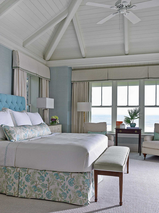 Master Bedroom. Beach House Bedroom. Beach House Bedroom with Blue Walls. Beach House Bedroom with Blue Grasscloth Wallpaper and coastal decor. Bed skirt, bedroom bench, blue and white, ceiling fan, vaulted ceiling, water view #BeachHouse #Bedroom #MasterBedroom #BeachHouseBedroom Cronk Duch Architecture. 