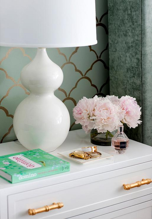 Bedroom. Grey bedroom features an accent wall clad in green and gold scallops wallpaper lined with a white nightstand with gold bamboo pulls, Worlds Away Marcus White & Gold Leaf Cabinet, topped with a white glass lamp. JWS Interiors.