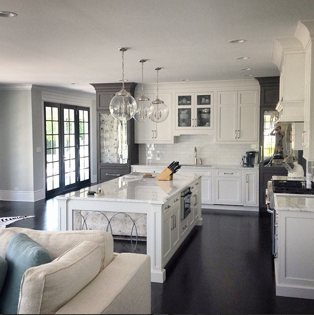 White and gray kitchen. White kitchen cabinets with kitchen island featuring antique mirror on sides. #WhiteKitchen #WhiteandgrayKitchen #MirrorIslandKitchen A. Perry Homes.