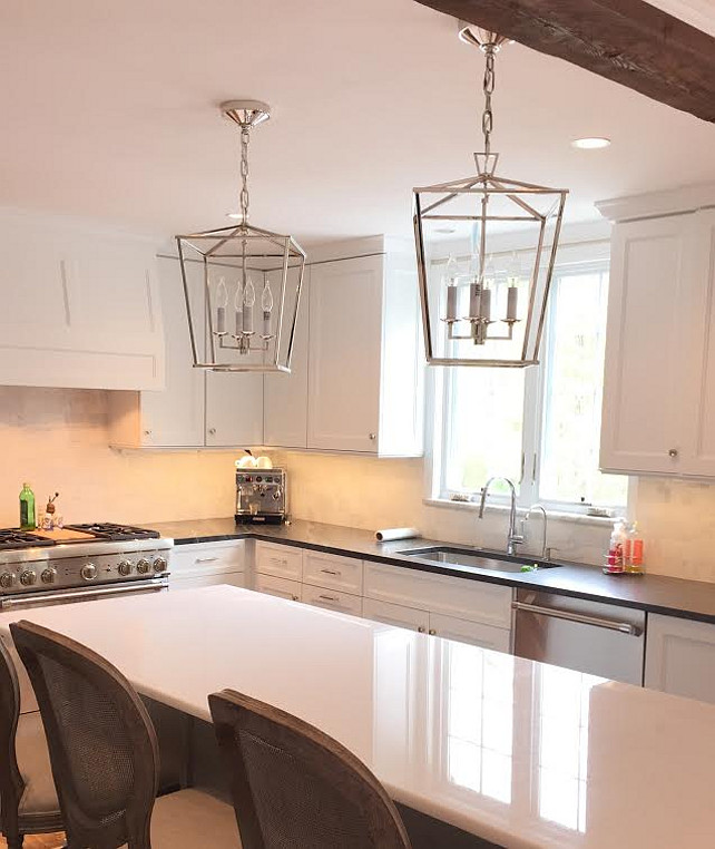 Kitchen Design. White kitchen with custom white cabinets. Perimeter countertop is Jet Mist - honed. Island countertop is Quartzite - Bianco Gem - polished. Hardware - Emtek - polished nickel. Counter Stools - Restoration Hardware. Pendant Lighting - Circa Lighting - Darlana Pendants. Andrea Korzon Interiors, LLC.