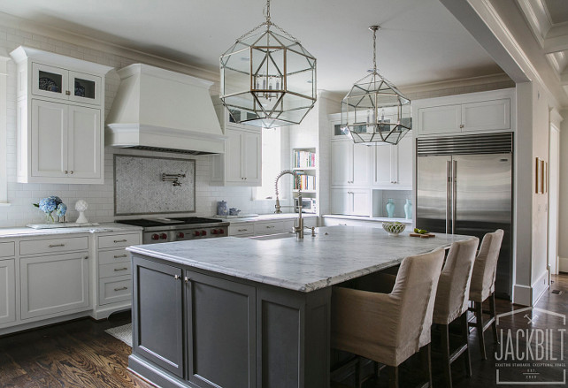 White and gray kitchen. White kitchen with gray island. The kitchen island paint color is Benjamin Moore 2134-30 Iron Mountain . This white and gray kitchen features white shaker cabinets paired with white marble countertops and a white subway tiled backsplash. #WhiteKitchen #GrayKItchen #White #Gray #Kitchen #WhiteCabinet #GrayIsland JackBilt Homes.