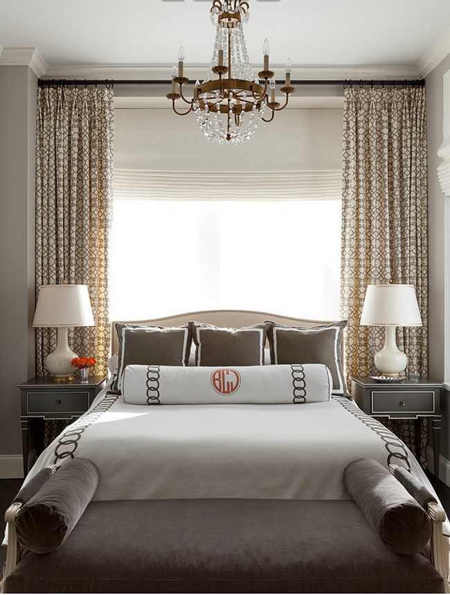 Master bedroom. Small master bedroom. In the master bedroom, custom bedding from Leontine Linens in New Orleans—in white piqué with a charcoal linen appliqué—sets a refined tone. The Hickory Chair bench is upholstered in charcoal velvet. Custom curtains made of a Kravet fabric add an interesting pattern. Gourd ceramic lamps by Festoni sit atop side tables by Vanguard Furniture. #Masterbedroom #SmallMasterBedroom Jenny Wolf Interiors.