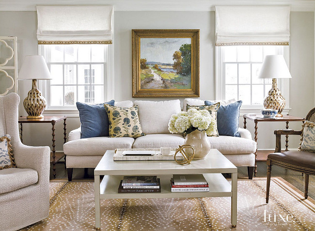 Manuel Canovas Pillows. Blue pillow fabric by Manuel Canovas adds pops of color to the family room’s neutral Lee Industries sofa in Wesley Flax; pheasant feather lamps by Bunny Williams Home perk up a pair of Theodore Alexander side tables. Beth Gularson. Helen Norman Photography