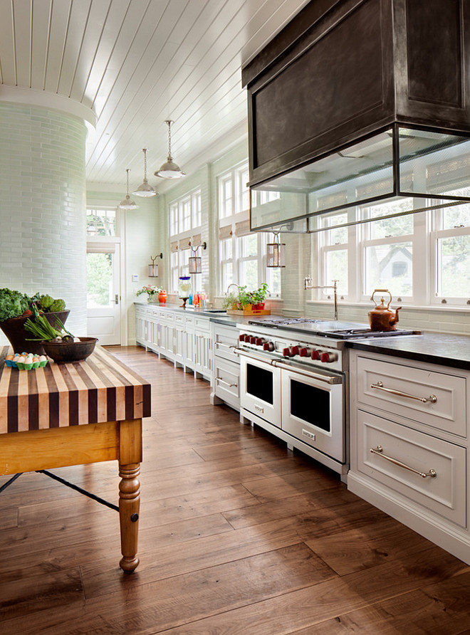 Floor to ceiling backsplash. Kitchen with floor to ceiling backsplash. Floor to ceiling kitchen backsplash. Kitchen floor to ceiling backsplash tiles, zinc hood and portable kitchen island. Wade Weissmann Architecture.